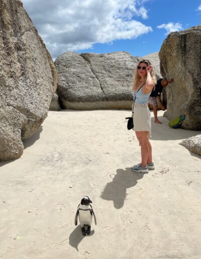 cape town woman next to penguin at boulders beach
